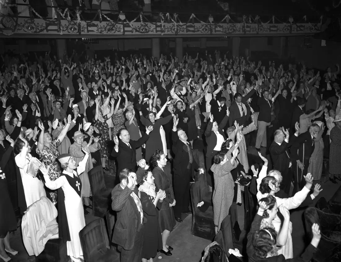 Interior of Angelus Temple during a 1942 service, with a large audience filling the tiered auditorium.