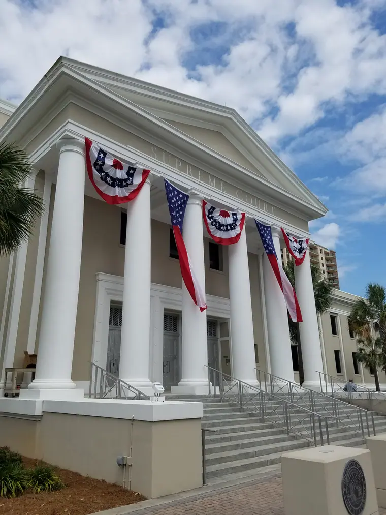Side view of the Florida Supreme Court Building in Tallahassee draped in red, white and blue bunting.