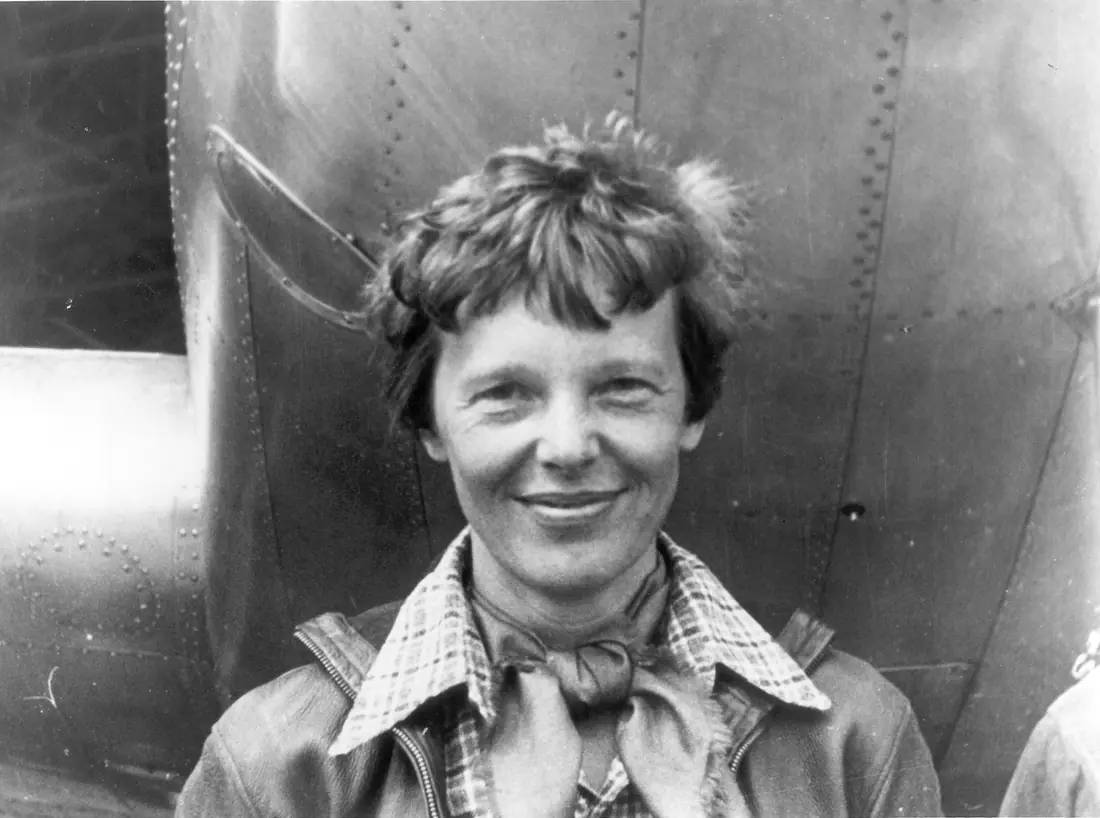 Amelia Earhart standing beneath the nose of her Lockheed Model 10-E Electra, March 1937.