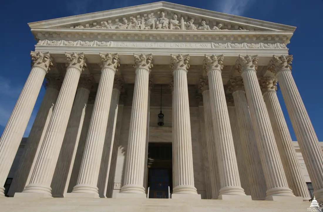 West front of the United States Supreme Court building, marble columns and pediment above a broad flight of steps.