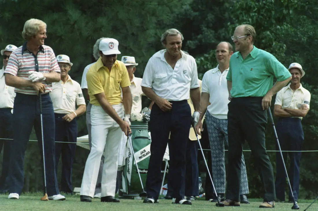 Four men on a golf course fairway, one of them the President of the United States, watching a shot.