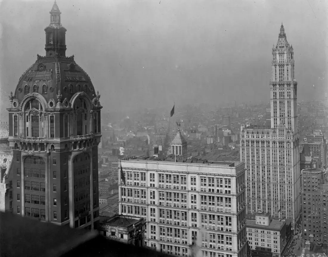 Lower Manhattan around 1918, with the Singer Building at left and the Woolworth Building at right rising above Broadway.