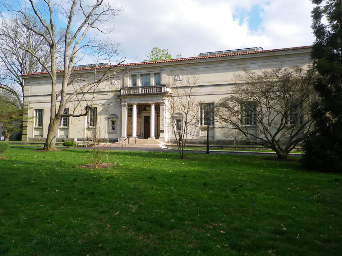 The original Barnes Foundation gallery building in Merion, Pennsylvania, a limestone building set among trees.