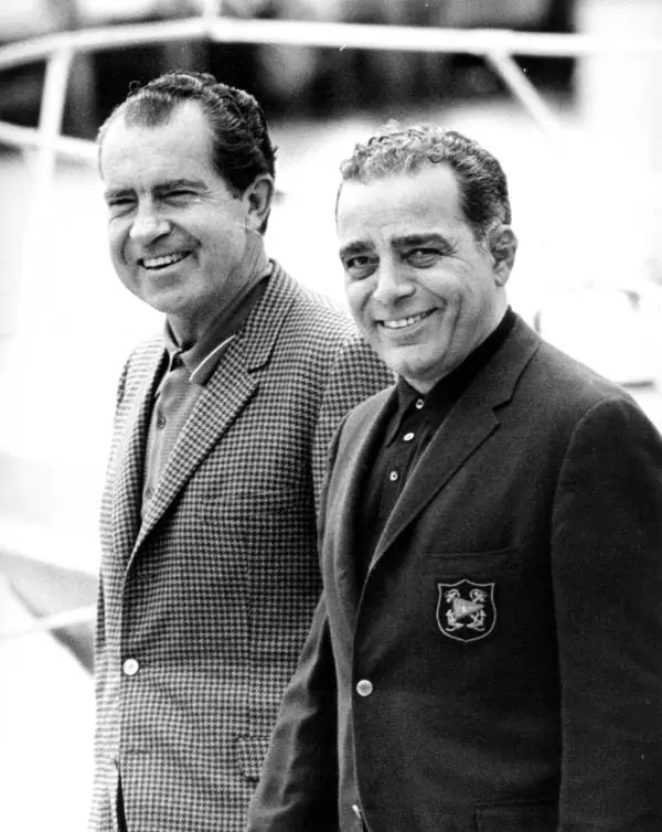President Richard Nixon standing with his friend Bebe Rebozo.