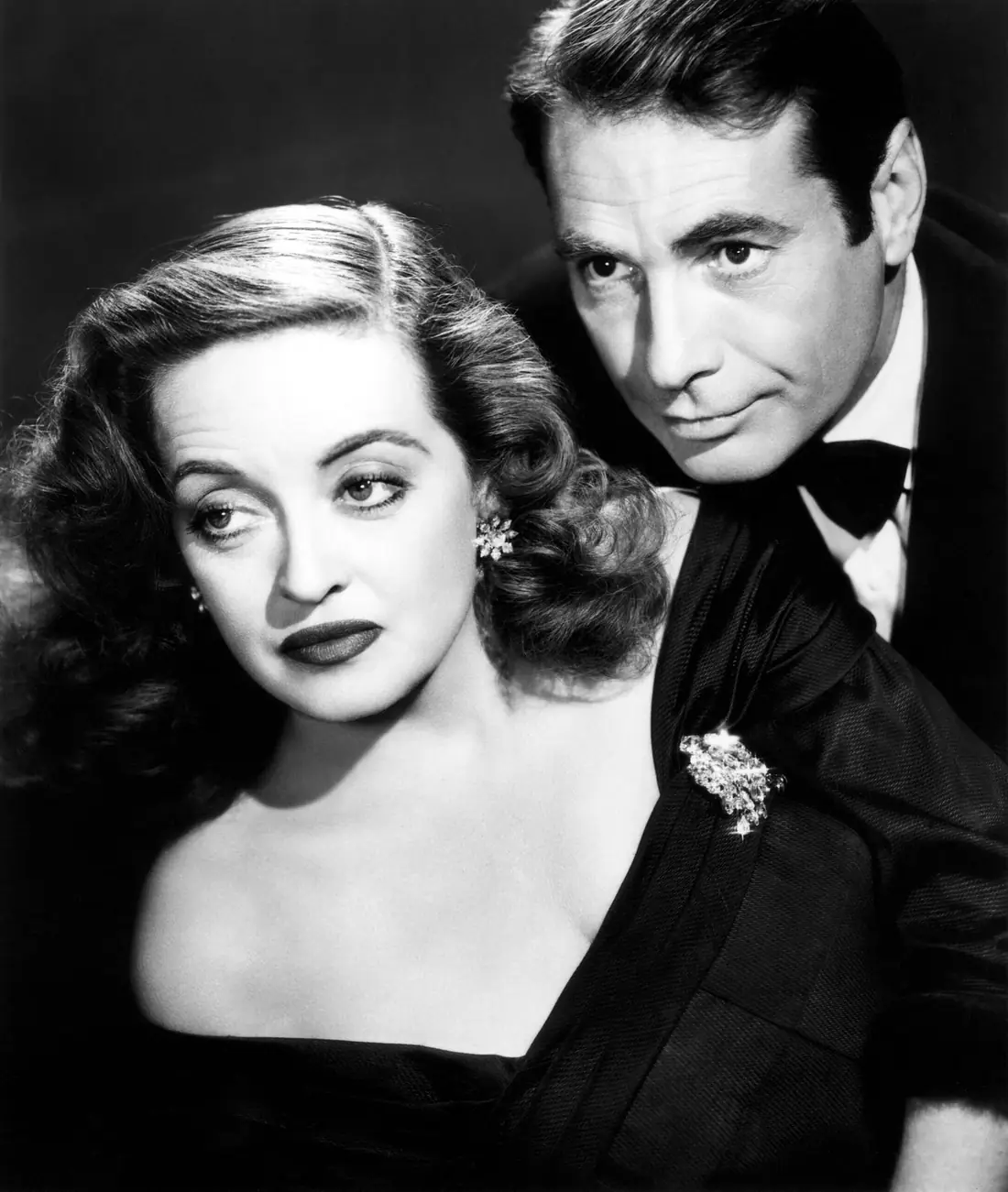 Two actors photographed together in a 1950 film still.