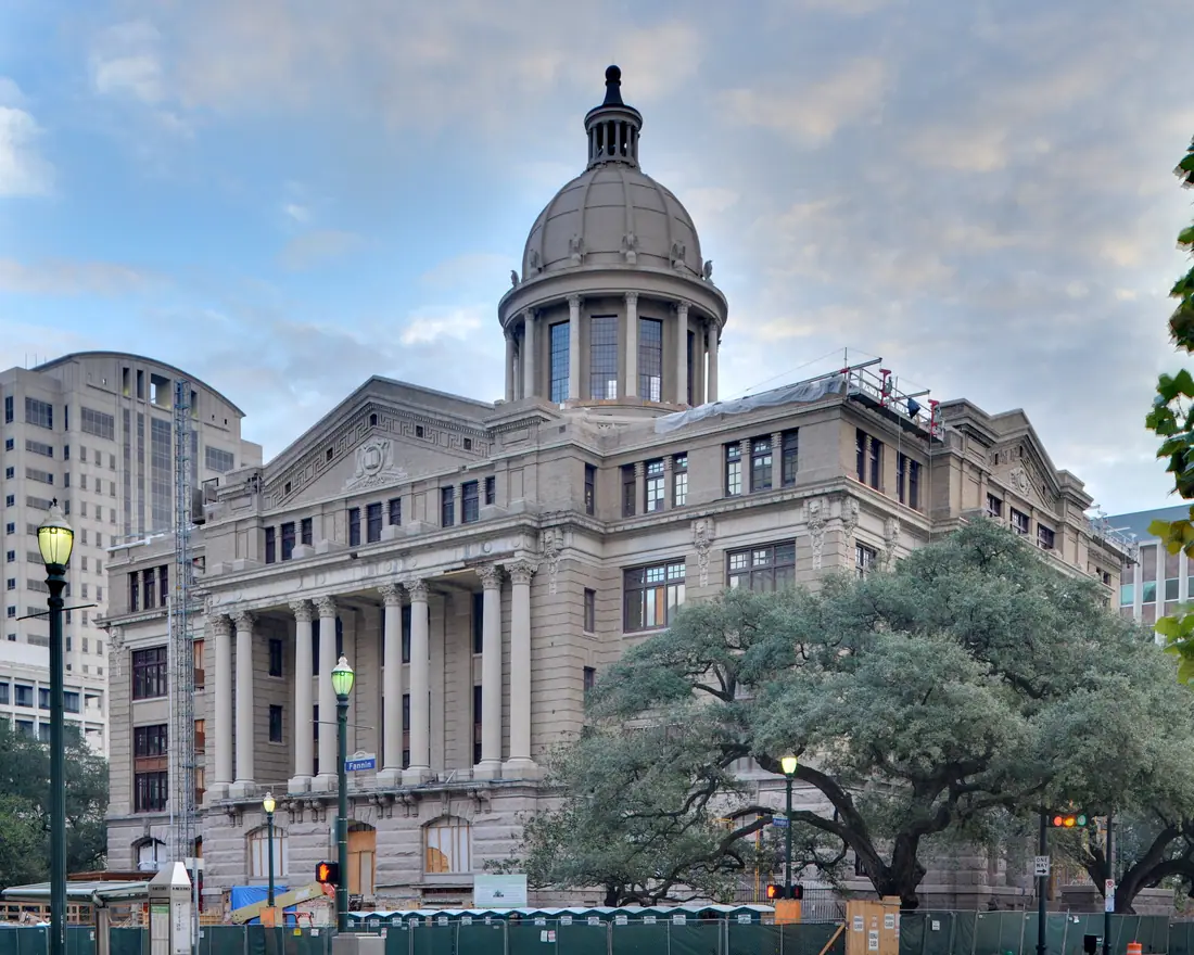 A restored 1910 neoclassical courthouse in red brick and limestone with a central dome.