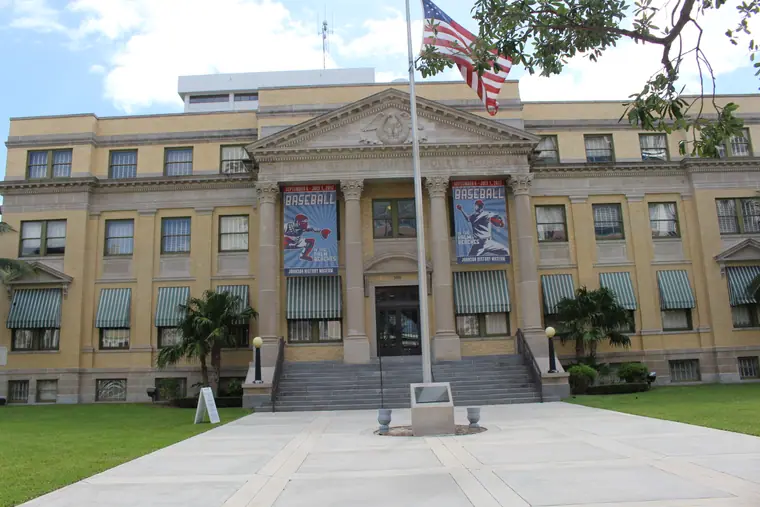 The restored 1916 Palm Beach County Courthouse in West Palm Beach, a classical building with columns and a flagpole.