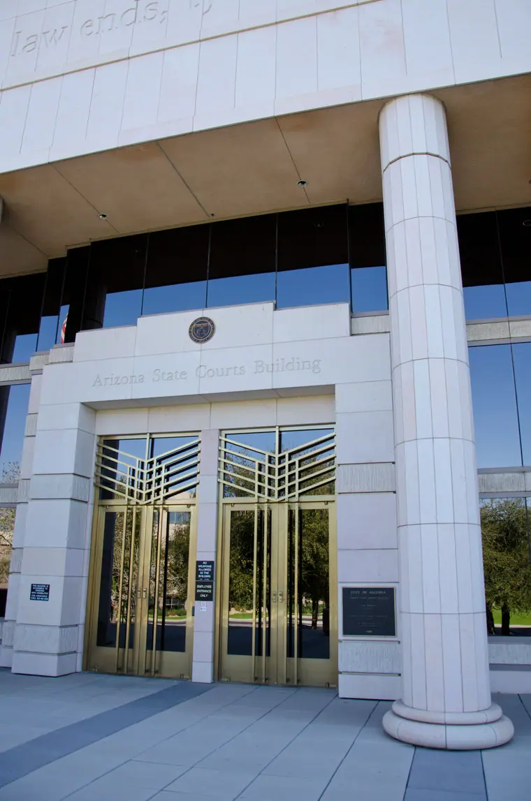 The Arizona Supreme Court building in downtown Phoenix, seen from below against a clear sky.
