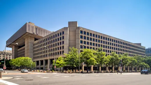 A wide view of the concrete facade of the J. Edgar Hoover Building, FBI headquarters in Washington, DC.
