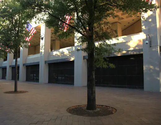 The blank ground-floor south facade of the J. Edgar Hoover Building along Pennsylvania Avenue.