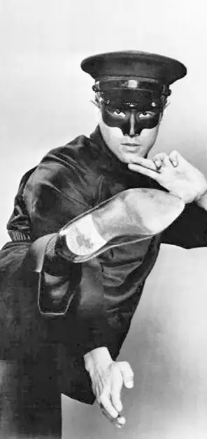 Bruce Lee standing in costume as Kato in a 1966 ABC Television photograph for The Green Hornet.