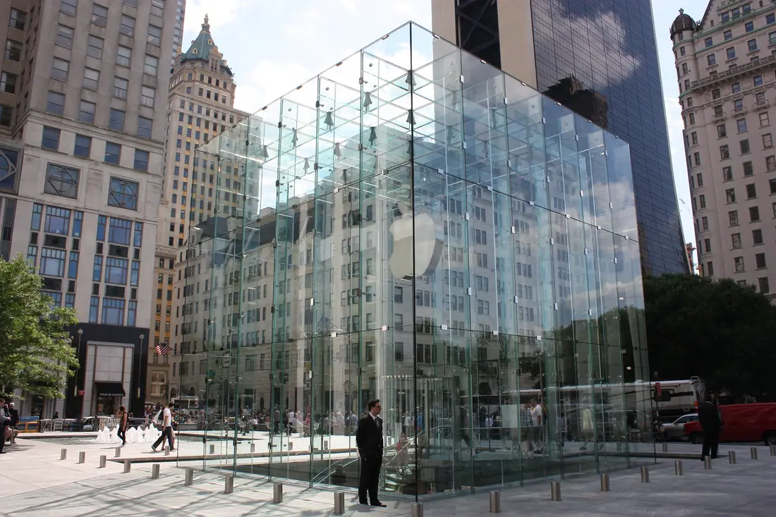 The glass cube entrance to the Apple Store on Fifth Avenue in New York at night.