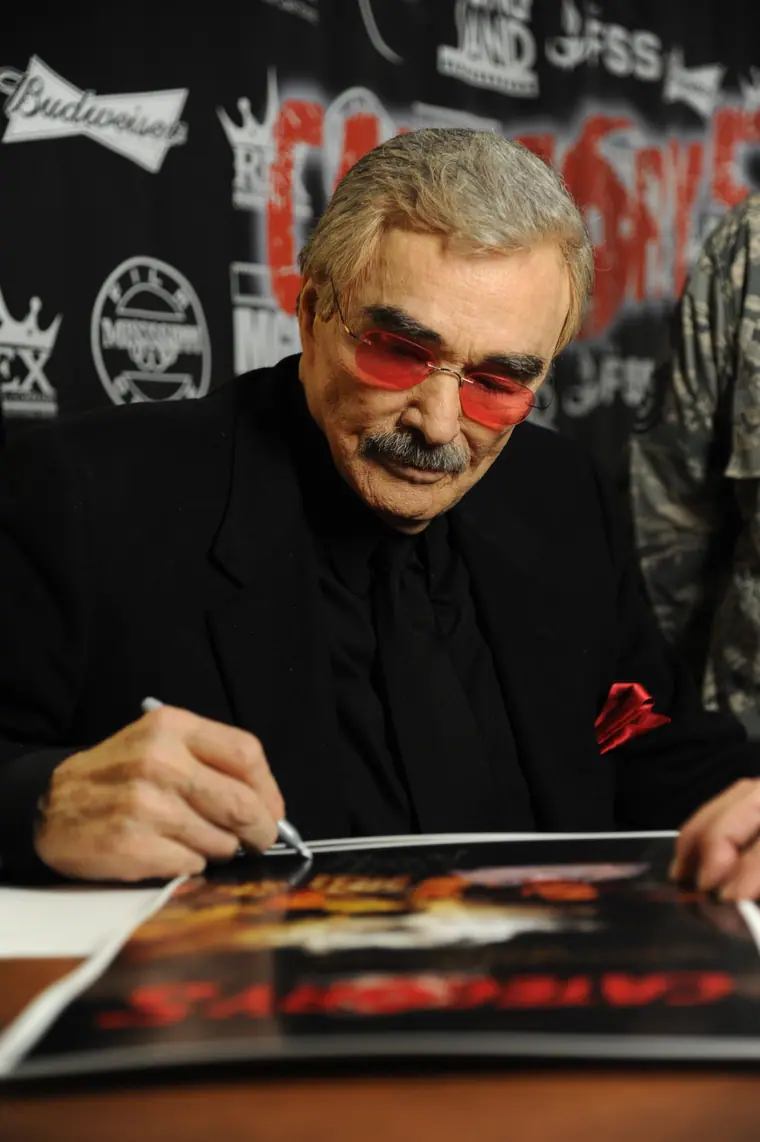 Burt Reynolds signing posters for Air Force personnel at Keesler Air Force Base in Mississippi.