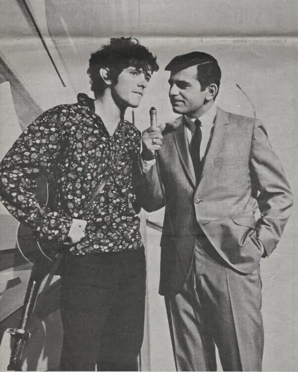 Casey Kasem holding a microphone while interviewing the singer Donovan on the television programme Shebang in 1965.