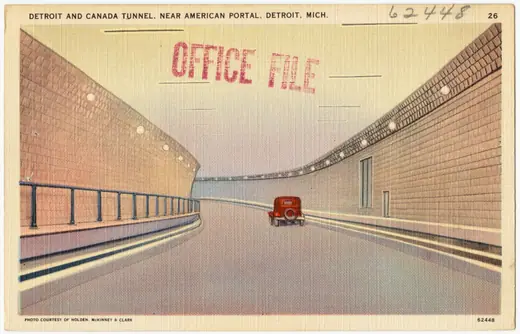 Linen postcard of a tiled road tunnel entrance with period cars approaching the American portal.