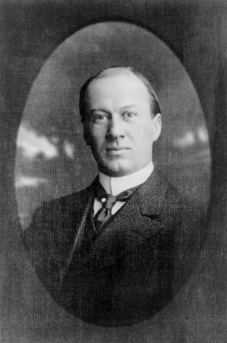 Formal head-and-shoulders portrait of a middle-aged man in a high collar and dark suit, looking slightly away from the camera.