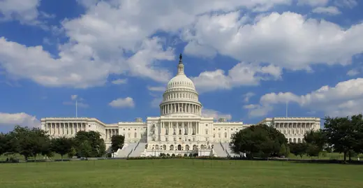 The west front of the United States Capitol under a clear sky.