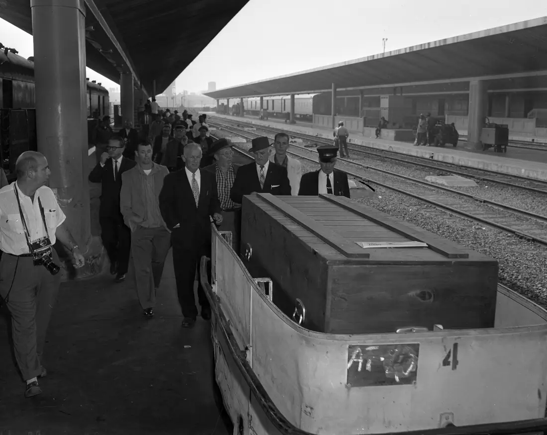 A coffin being unloaded on a railway platform, photographed by a newspaper in 1959.