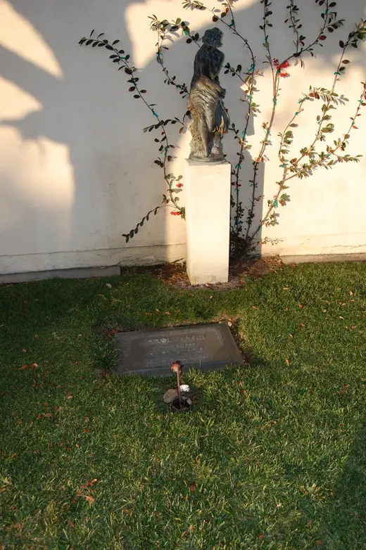 A flat memorial marker set in grass at a California cemetery.
