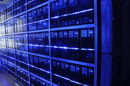 Server racks lining an aisle in a data centre.
