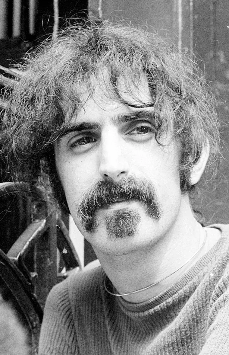 Portrait photograph of Frank Zappa with long hair and moustache, Netherlands, June 1970.