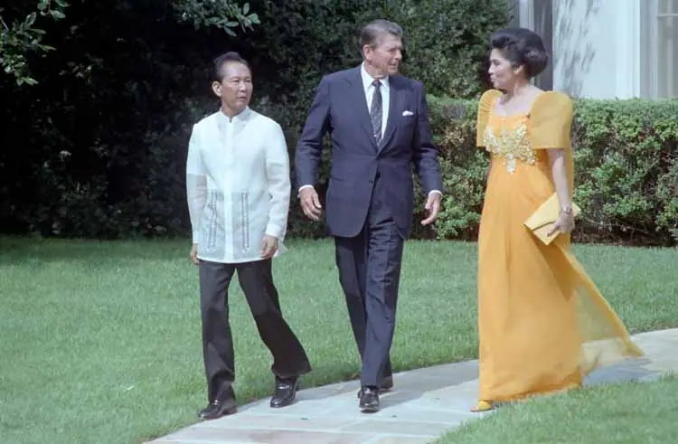 Four figures in formal dress standing together outside the Oval Office during a state visit.