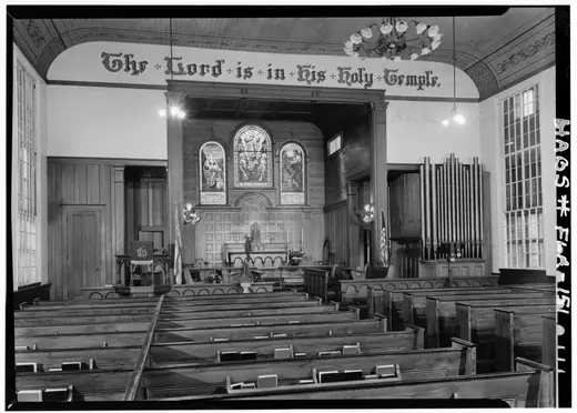 Interior of Trinity Episcopal Church, Apalachicola, looking toward the chancel, with box pews and a painted ceiling.