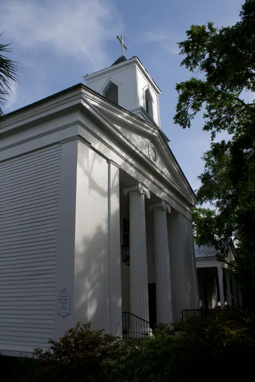 Steeple of Trinity Episcopal Church at Gorrie Square, Apalachicola, Florida, against a clear sky.