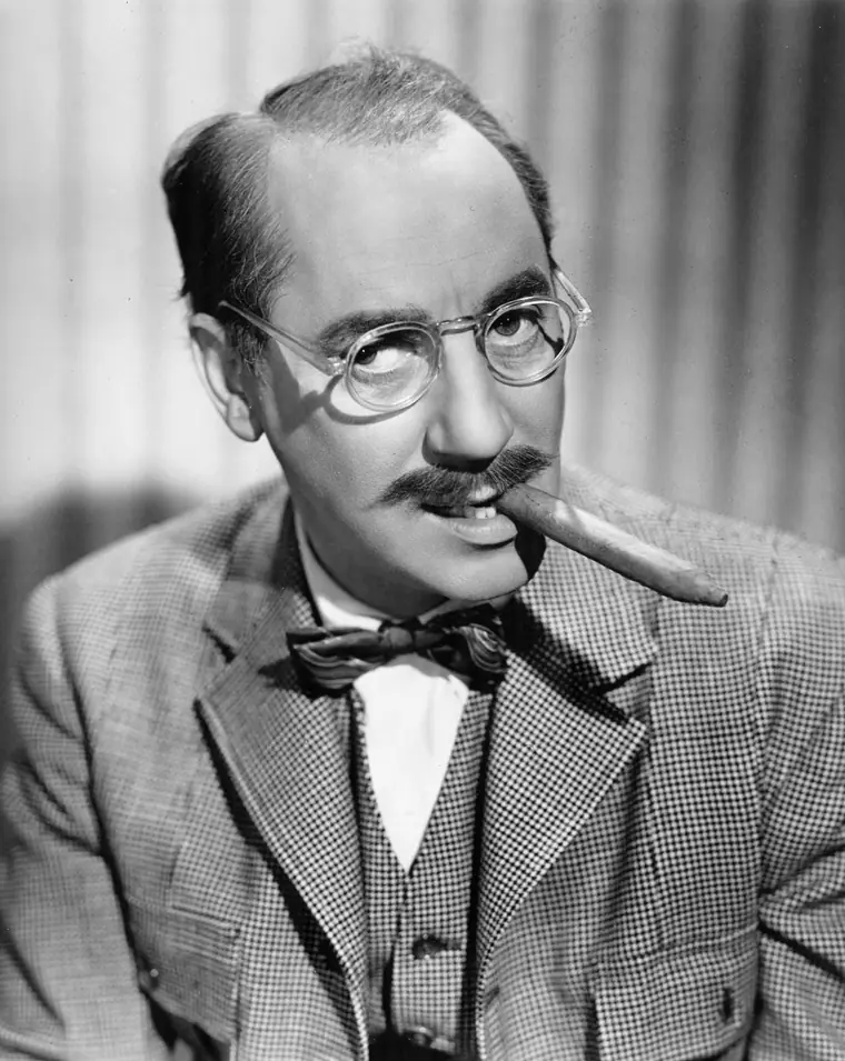 Studio portrait of a comedian with a moustache and dark eyebrows, circa 1940.