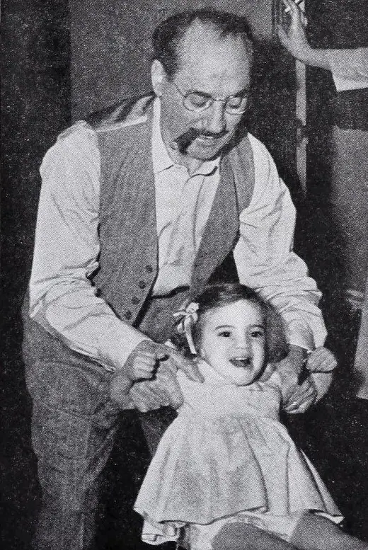 A father holding his two-year-old daughter, magazine photograph from 1949.