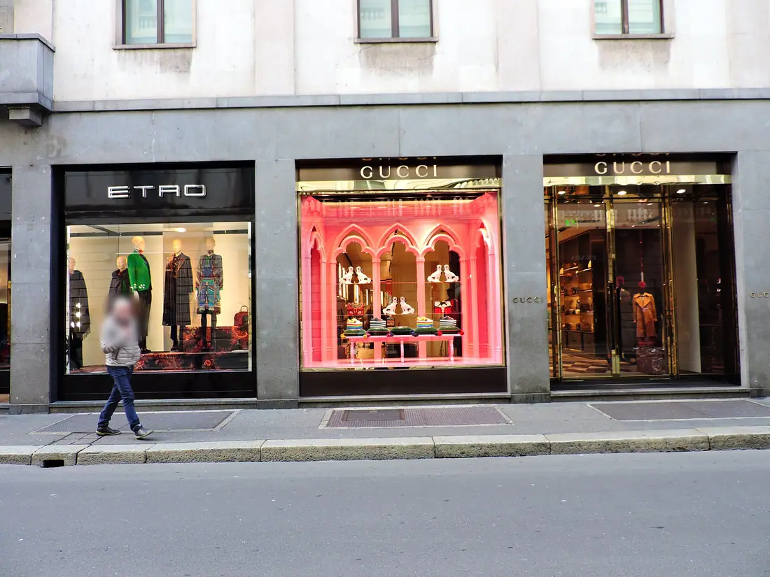 Via Monte Napoleone in Milan's fashion district, lined with luxury storefronts.