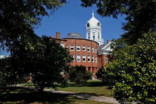 The white-columned historic Monroe County Courthouse in Monroeville, Alabama, with its clock cupola.