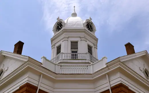 Street-level view of the old Monroe County Courthouse building in Monroeville, Alabama.