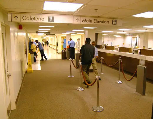 Interior hall of the NIH Clinical Center, a long light-filled corridor with a curved ceiling.