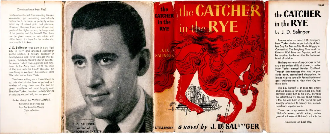 The full wraparound first-edition dust jacket of The Catcher in the Rye, with a carousel horse illustration and the author portrait on the rear flap.