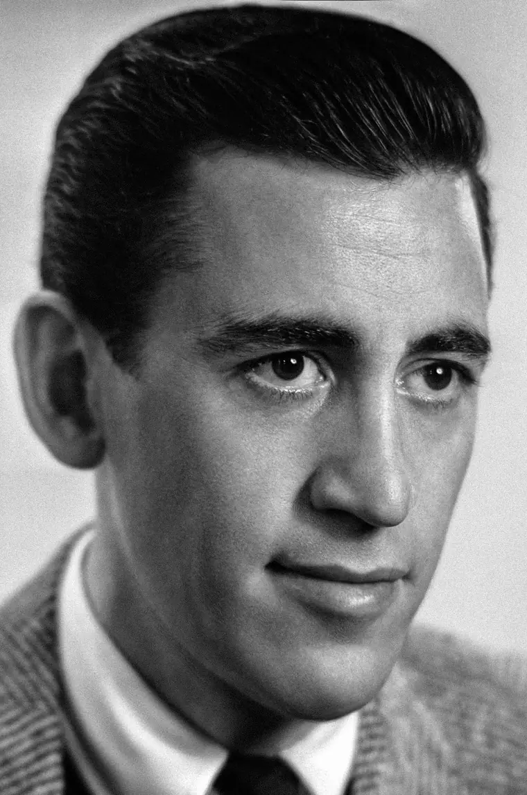 Black-and-white portrait of a young J.D. Salinger in a dark jacket, looking directly at the camera.
