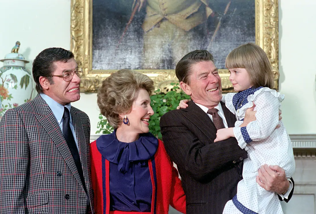A comedian and a child meeting the President and First Lady in the Oval Office in 1981.