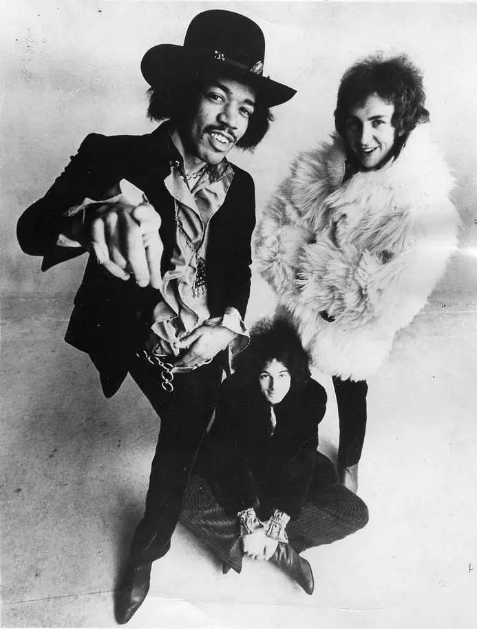 Record-label publicity photograph of the Jimi Hendrix Experience, with Hendrix at the front.