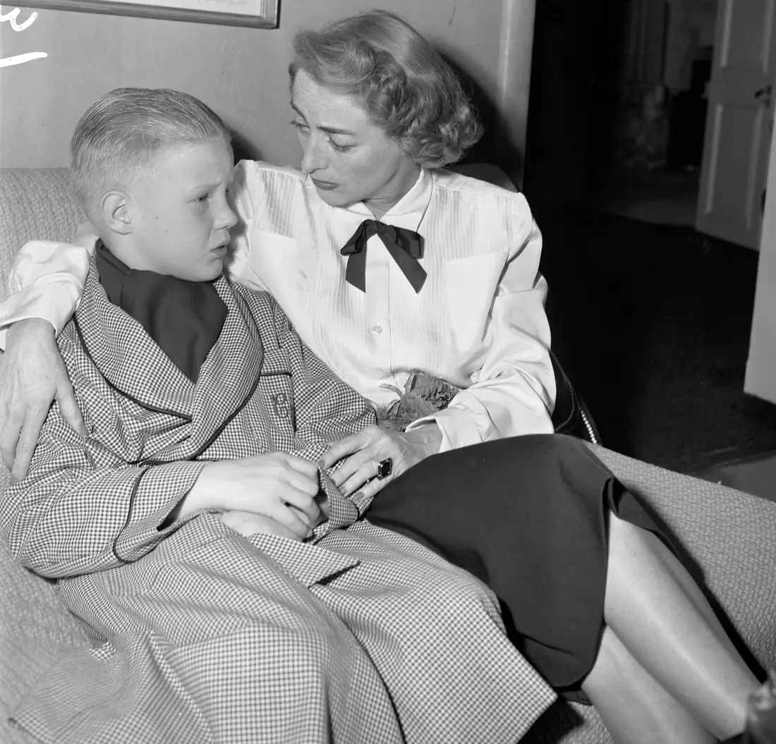 A mother seated with her young son, photographed by a newspaper in 1951.