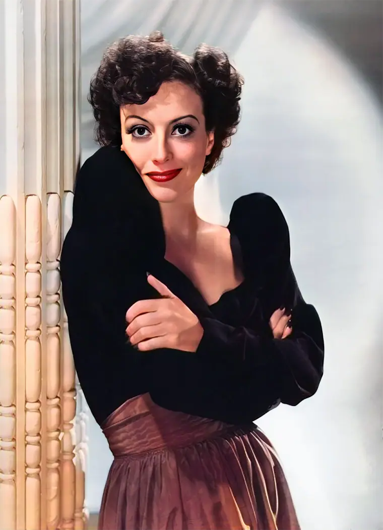 Studio portrait of an actress in 1939, hair swept back, looking directly at the camera.