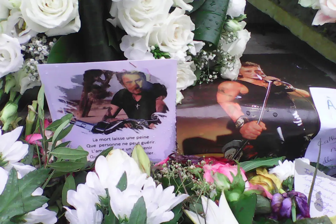 Photographs and flowers left in tribute to Johnny Hallyday on the steps of the Madeleine church in Paris.