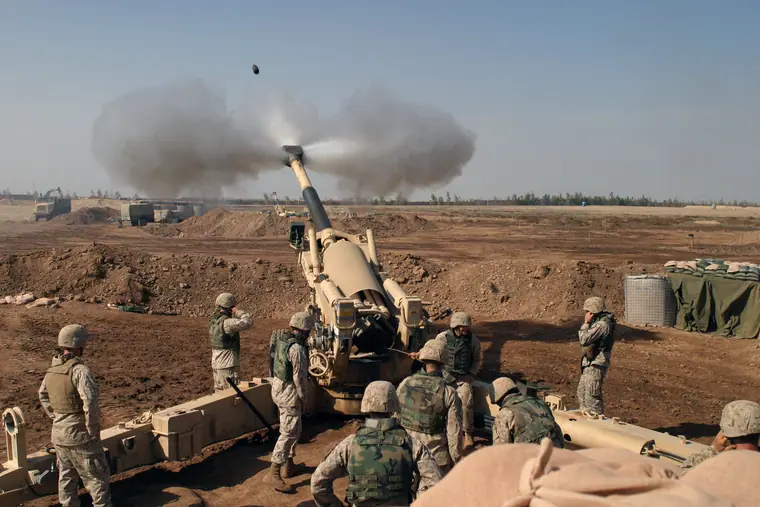 United States Marines crewing an M-198 howitzer during operations at Fallujah, Iraq, on 11 November 2004.