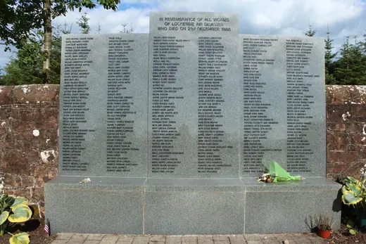 The stone memorial to the Lockerbie air disaster, carved with names, in Dryfesdale Cemetery.