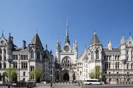 The full Gothic Revival facade of the Royal Courts of Justice in London seen from the Strand.