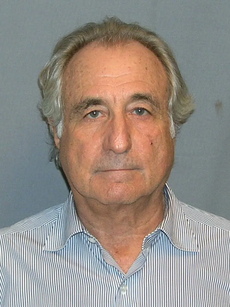 Booking photograph of an older man in a dark jacket against a plain background.