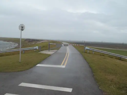 The grassed embankment of the Herbert Hoover Dike beside Lake Okeechobee in Palm Beach County.