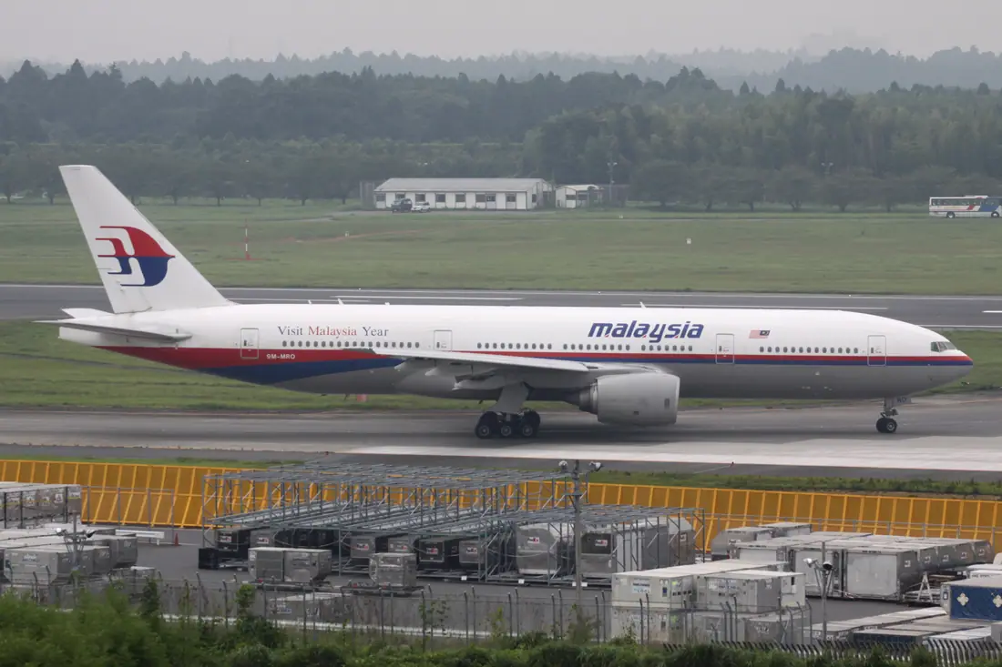 A Malaysia Airlines Boeing 777-200ER, registration 9M-MRO, holding short of a runway at Narita International Airport in 2009.