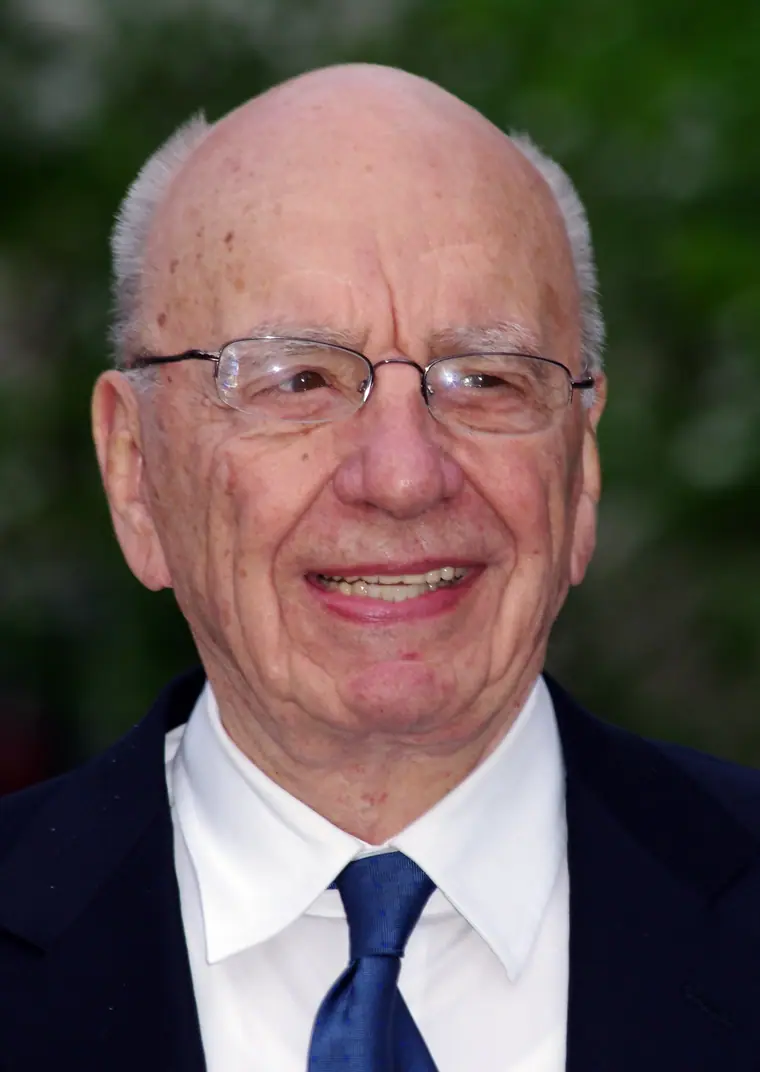 Rupert Murdoch in a dark suit and open-collared shirt at an evening event in New York.