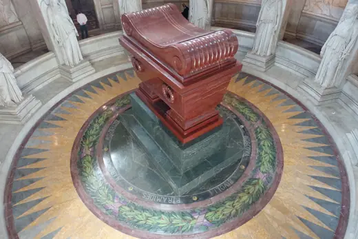 The red porphyry sarcophagus holding Napoleon's remains, in the circular crypt beneath the dome of Les Invalides in Paris.