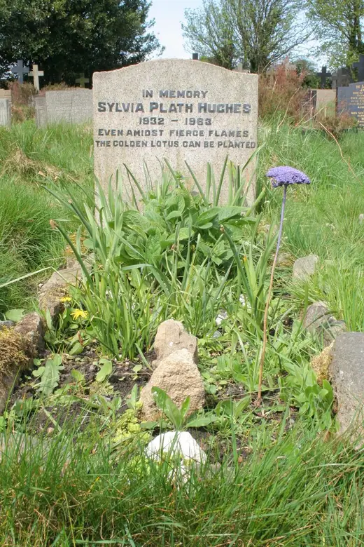 Sylvia Plath's grave marker seen among other headstones in the Heptonstall churchyard.